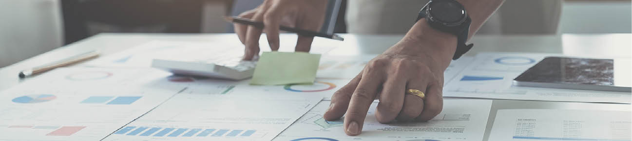 Businessman hand holding pen and pointing at financial paperwork with financial network diagram. 
