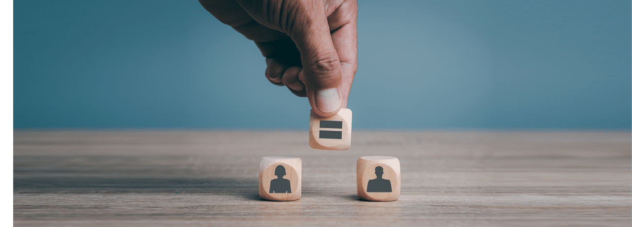 Man's hand is placing wooden blocks on the table, gender equality concepts, human discrimination, liberties and gender issues, reducing social inequality.